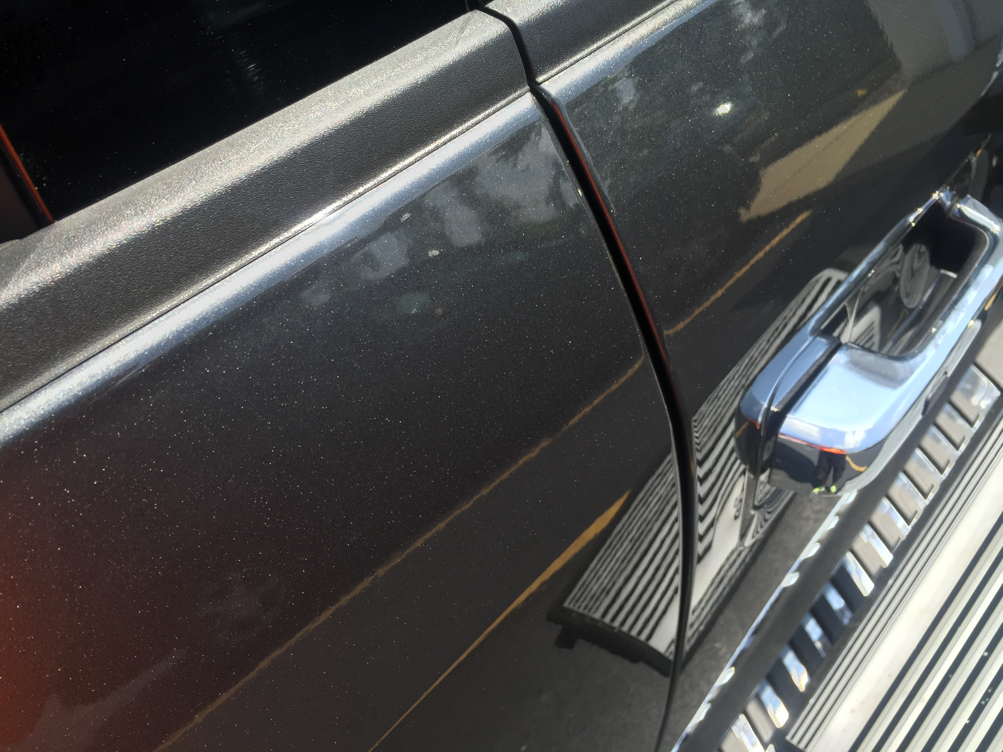 www.217dent.com 2015 Grey Aluminum Ford F-150 passenger side door dent removal near door-handle.
