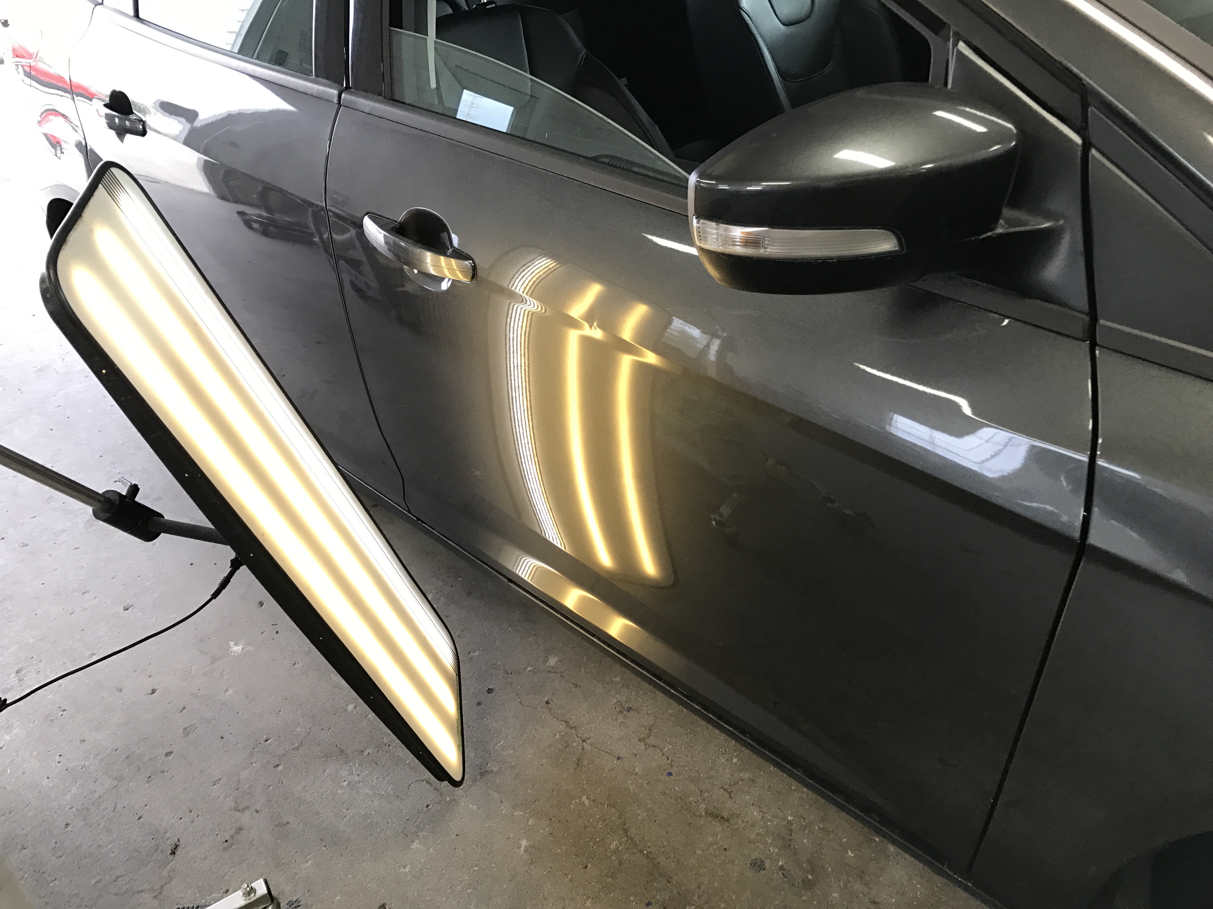 2015 Ford Focus, Paintless Dent, Dent Tech, Dent Removal, This is the before image of the vehicle's damage, if you look closely you can see the dent in the body line of the passenger door, Mobile Dent Removal Springfield, Decatur, Illinois