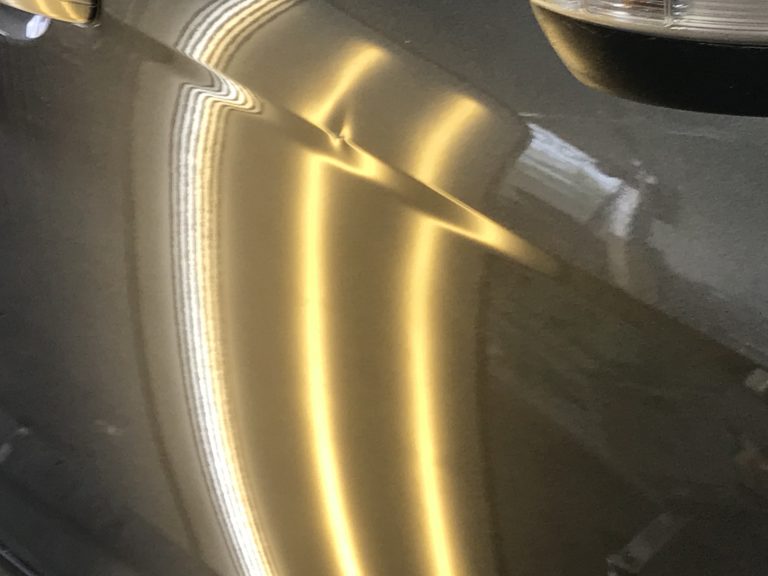 2015 Ford Focus: sharp body line dent in the passenger door, before paintless dent repair