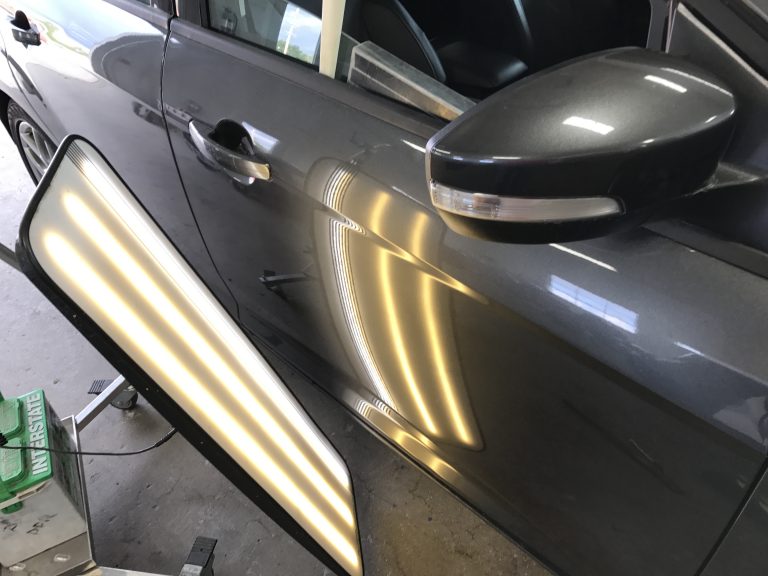 2015 Ford Focus: sharp body line dent in the passenger door, after paintless dent repair