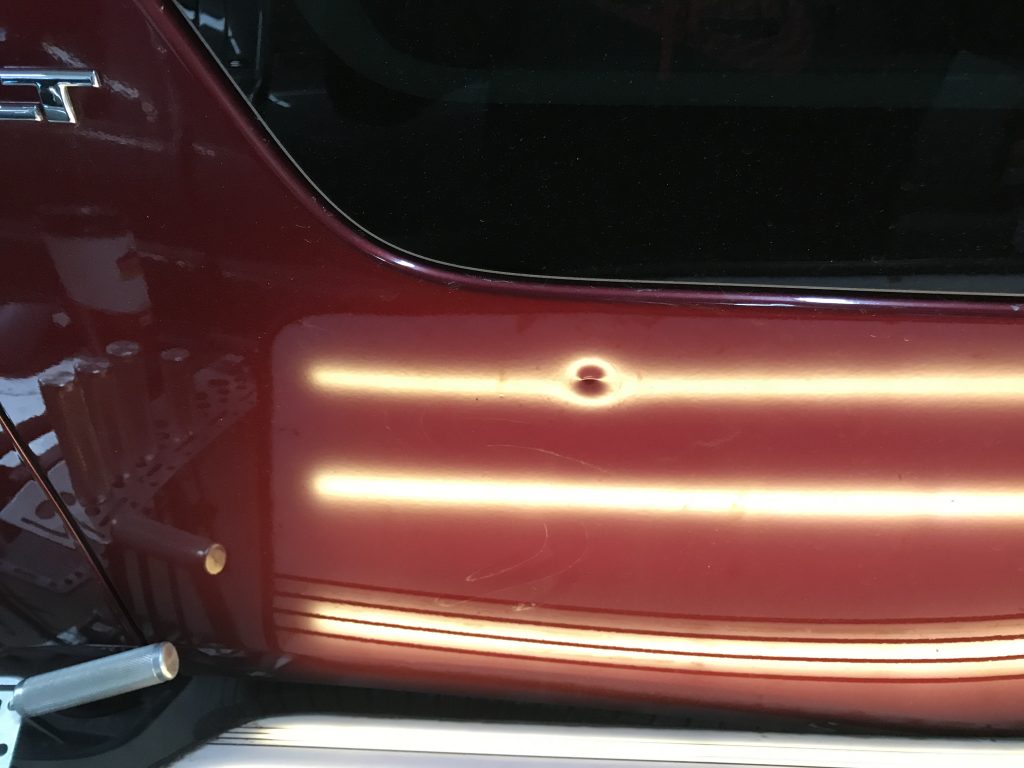 Springfield, IL Dent repair, http://217Dent.com  Photo of a sharp dent in the rear quarter of a 2010 Yukon. (During Image)
