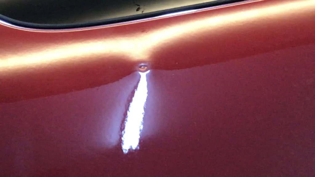 Springfield, IL Dent repair, http://217Dent.com  Photo of a sharp dent in the rear quarter of a 2010 Yukon. (During Image)