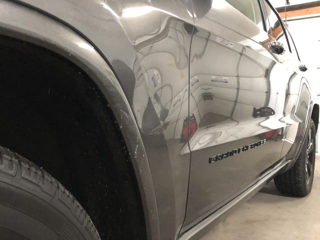 Large dent in the fender of this Grand Cherokee, Before the paintless dent removal process was performed by Michael Bocek out of Springfield, IL http://217Dent.com