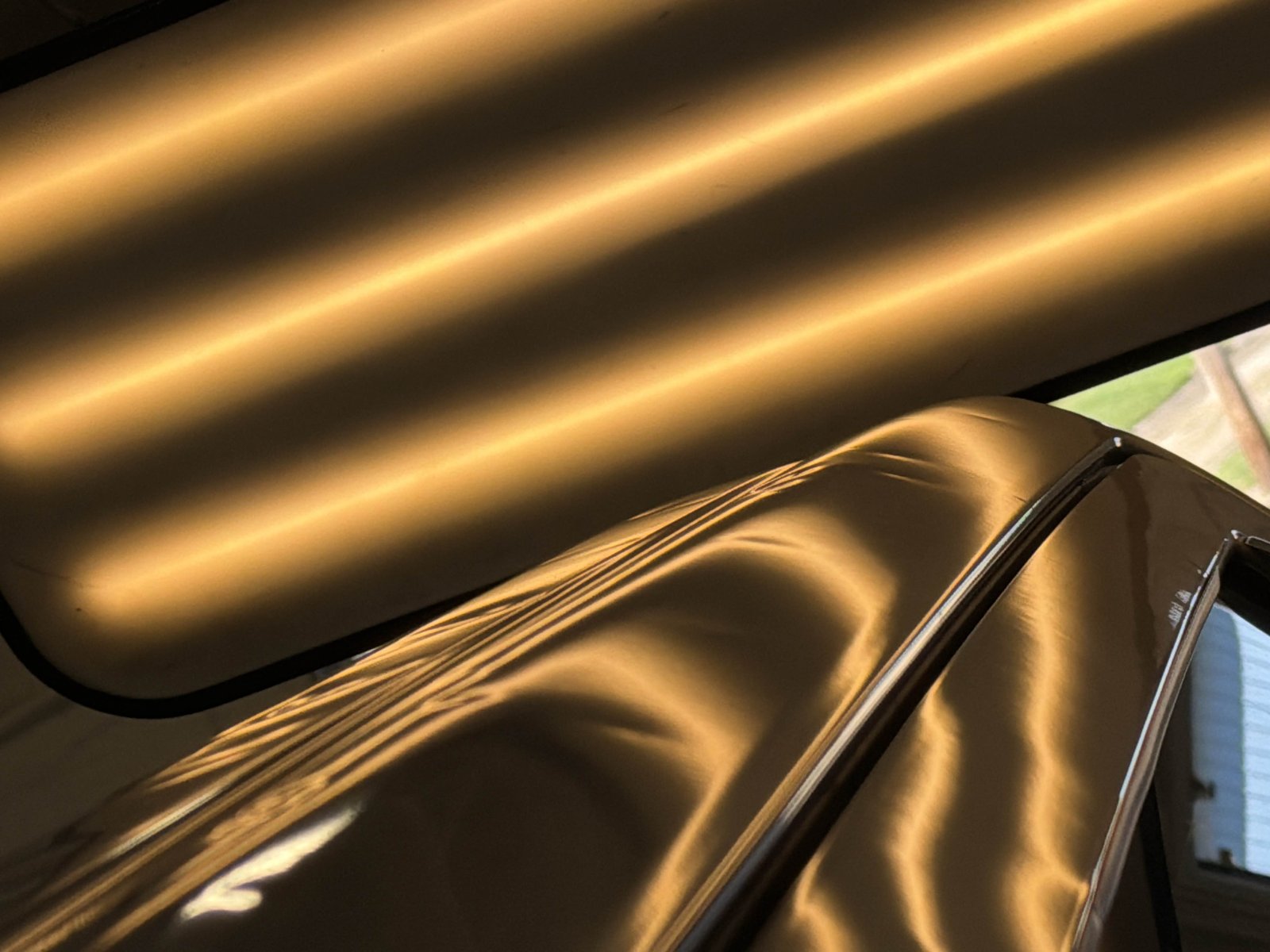 PDR light board above the driver-side roof rail of a silver 2024 Toyota Tundra, hail dents bending the light