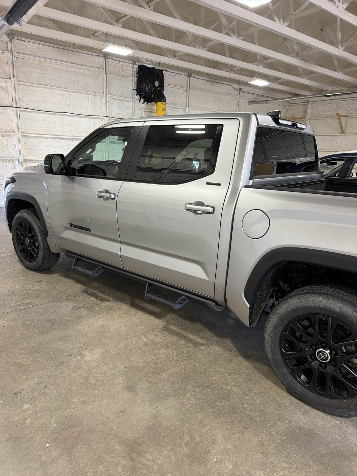 Silver 2024 Toyota Tundra crew cab in the shop, driver side