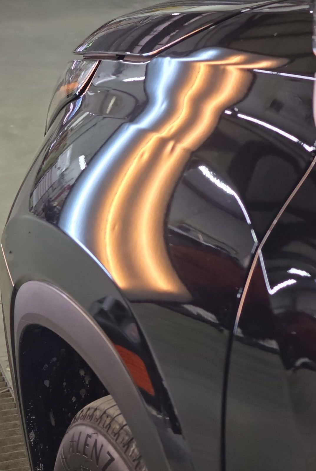Driver front fender of a black 2025 Toyota Highlander Hybrid under PDR light